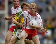 26 September 2004; Martin Murray, Tyrone, in action against Darren O'Sullivan, Mayo. All-Ireland Minor Football Championship Final, Kerry v Tyrone, Croke Park, Dublin. Picture credit; Ray McManus / SPORTSFILE *** Local Caption *** Any photograph taken by SPORTSFILE during, or in connection with, the 2004 All-Ireland Minor Football Final which displays GAA logos or contains an image or part of an image of any GAA intellectual property, or, which contains images of a GAA player/players in their playing uniforms, may only be used for editorial and non-advertising purposes.  Use of photographs for advertising, as posters or for purchase separately is strictly prohibited unless prior written approval has been obtained from the Gaelic Athletic Association.
