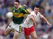 26 September 2004; Brian Moran, Kerry, in action against Niall Kerr, Tyrone. All-Ireland Minor Football Championship Final, Kerry v Tyrone, Croke Park, Dublin. Picture credit; Ray McManus / SPORTSFILE *** Local Caption *** Any photograph taken by SPORTSFILE during, or in connection with, the 2004 All-Ireland Minor Football Final which displays GAA logos or contains an image or part of an image of any GAA intellectual property, or, which contains images of a GAA player/players in their playing uniforms, may only be used for editorial and non-advertising purposes.  Use of photographs for advertising, as posters or for purchase separately is strictly prohibited unless prior written approval has been obtained from the Gaelic Athletic Association.
