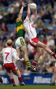 26 September 2004; Shane O'Hagan, Tyrone, in action against Brian Moran, Mayo. All-Ireland Minor Football Championship Final, Kerry v Tyrone, Croke Park, Dublin. Picture credit; Ray McManus / SPORTSFILE *** Local Caption *** Any photograph taken by SPORTSFILE during, or in connection with, the 2004 All-Ireland Minor Football Final which displays GAA logos or contains an image or part of an image of any GAA intellectual property, or, which contains images of a GAA player/players in their playing uniforms, may only be used for editorial and non-advertising purposes.  Use of photographs for advertising, as posters or for purchase separately is strictly prohibited unless prior written approval has been obtained from the Gaelic Athletic Association.