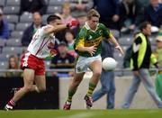 26 September 2004; Paul O'Connor, Kerry, in action against Niall Gilmore, Tyrone. All-Ireland Minor Football Championship Final, Kerry v Tyrone, Croke Park, Dublin. Picture credit; Ray McManus / SPORTSFILE *** Local Caption *** Any photograph taken by SPORTSFILE during, or in connection with, the 2004 All-Ireland Minor Football Final which displays GAA logos or contains an image or part of an image of any GAA intellectual property, or, which contains images of a GAA player/players in their playing uniforms, may only be used for editorial and non-advertising purposes.  Use of photographs for advertising, as posters or for purchase separately is strictly prohibited unless prior written approval has been obtained from the Gaelic Athletic Association.