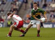 26 September 2004; Michael O'Donoghue, Kerry, in action against Paul Marlow, Tyrone. All-Ireland Minor Football Championship Final, Kerry v Tyrone, Croke Park, Dublin. Picture credit; Damien Eagers / SPORTSFILE *** Local Caption *** Any photograph taken by SPORTSFILE during, or in connection with, the 2004 All-Ireland Minor  Football Final which displays GAA logos or contains an image or part of an image of any GAA intellectual property, or, which contains images of a GAA player/players in their playing uniforms, may only be used for editorial and non-advertising purposes.  Use of photographs for advertising, as posters or for purchase separately is strictly prohibited unless prior written approval has been obtained from the Gaelic Athletic Association.