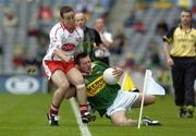 26 September 2004; Mark Evans, Kerry, in action against Damian Burke, Tyrone. All-Ireland Minor Football Championship Final, Kerry v Tyrone, Croke Park, Dublin. Picture credit; Damien Eagers / SPORTSFILE *** Local Caption *** Any photograph taken by SPORTSFILE during, or in connection with, the 2004 All-Ireland Minor  Football Final which displays GAA logos or contains an image or part of an image of any GAA intellectual property, or, which contains images of a GAA player/players in their playing uniforms, may only be used for editorial and non-advertising purposes.  Use of photographs for advertising, as posters or for purchase separately is strictly prohibited unless prior written approval has been obtained from the Gaelic Athletic Association.
