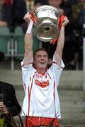 26 September 2004; Tyrone captain Marc Cunningham lifts the Tom Markham Cup after victory over Kerry. All-Ireland Minor Football Championship Final, Kerry v Tyrone, Croke Park, Dublin. Picture credit; Damien Eagers / SPORTSFILE *** Local Caption *** Any photograph taken by SPORTSFILE during, or in connection with, the 2004 All-Ireland Minor  Football Final which displays GAA logos or contains an image or part of an image of any GAA intellectual property, or, which contains images of a GAA player/players in their playing uniforms, may only be used for editorial and non-advertising purposes.  Use of photographs for advertising, as posters or for purchase separately is strictly prohibited unless prior written approval has been obtained from the Gaelic Athletic Association.