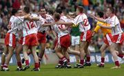 26 September 2004; Tyrone players celebrate after victory over Kerry. All-Ireland Minor Football Championship Final, Kerry v Tyrone, Croke Park, Dublin. Picture credit; Damien Eagers / SPORTSFILE *** Local Caption *** Any photograph taken by SPORTSFILE during, or in connection with, the 2004 All-Ireland Minor  Football Final which displays GAA logos or contains an image or part of an image of any GAA intellectual property, or, which contains images of a GAA player/players in their playing uniforms, may only be used for editorial and non-advertising purposes.  Use of photographs for advertising, as posters or for purchase separately is strictly prohibited unless prior written approval has been obtained from the Gaelic Athletic Association.