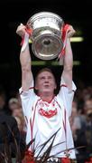 26 September 2004; Tyrone captain Marc Cunningham lifts the Tom Markham cup after victory over Kerry. All-Ireland Minor Football Championship Final, Kerry v Tyrone, Croke Park, Dublin. Picture credit; Brian Lawless / SPORTSFILE *** Local Caption *** Any photograph taken by SPORTSFILE during, or in connection with, the 2004 All-Ireland Minor Football Final which displays GAA logos or contains an image or part of an image of any GAA intellectual property, or, which contains images of a GAA player/players in their playing uniforms, may only be used for editorial and non-advertising purposes.  Use of photographs for advertising, as posters or for purchase separately is strictly prohibited unless prior written approval has been obtained from the Gaelic Athletic Association.