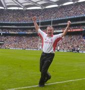 26 September 2004; Tyrone manager Liam Doyle celebrates at the final whistle. All-Ireland Minor Football Championship Final, Kerry v Tyrone, Croke Park, Dublin. Picture credit; Brian Lawless / SPORTSFILE *** Local Caption *** Any photograph taken by SPORTSFILE during, or in connection with, the 2004 All-Ireland Minor Football Final which displays GAA logos or contains an image or part of an image of any GAA intellectual property, or, which contains images of a GAA player/players in their playing uniforms, may only be used for editorial and non-advertising purposes.  Use of photographs for advertising, as posters or for purchase separately is strictly prohibited unless prior written approval has been obtained from the Gaelic Athletic Association.