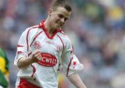26 September 2004; Ronan McCrory, Tyrone, celebrates a point against Kerry. All-Ireland Minor Football Championship Final, Kerry v Tyrone, Croke Park, Dublin. Picture credit; Brian Lawless / SPORTSFILE *** Local Caption *** Any photograph taken by SPORTSFILE during, or in connection with, the 2004 All-Ireland Minor Football Final which displays GAA logos or contains an image or part of an image of any GAA intellectual property, or, which contains images of a GAA player/players in their playing uniforms, may only be used for editorial and non-advertising purposes.  Use of photographs for advertising, as posters or for purchase separately is strictly prohibited unless prior written approval has been obtained from the Gaelic Athletic Association.