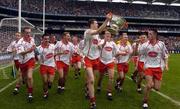 26 September 2004; The Tyrone team celebrate after victory over Kerry. All-Ireland Minor Football Championship Final, Kerry v Tyrone, Croke Park, Dublin. Picture credit; Damien Eagers / SPORTSFILE *** Local Caption *** Any photograph taken by SPORTSFILE during, or in connection with, the 2004 All-Ireland Minor  Football Final which displays GAA logos or contains an image or part of an image of any GAA intellectual property, or, which contains images of a GAA player/players in their playing uniforms, may only be used for editorial and non-advertising purposes.  Use of photographs for advertising, as posters or for purchase separately is strictly prohibited unless prior written approval has been obtained from the Gaelic Athletic Association.