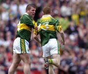 26 September 2004; Kerry's Dara O'Cinneide, left, congratulates team-mate Colm Cooper after he had scored his sides first goal. Bank of Ireland All-Ireland Senior Football Championship Final, Kerry v Mayo, Croke Park, Dublin. Picture credit; Brian Lawless / SPORTSFILE *** Local Caption *** Any photograph taken by SPORTSFILE during, or in connection with, the 2004 Bank of Ireland All-Ireland Senior Football Final which displays GAA logos or contains an image or part of an image of any GAA intellectual property, or, which contains images of a GAA player/players in their playing uniforms, may only be used for editorial and non-advertising purposes.  Use of photographs for advertising, as posters or for purchase separately is strictly prohibited unless prior written approval has been obtained from the Gaelic Athletic Association.