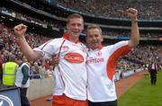 26 September 2004; Tyrone captain Marc Cunningham, left, and Tyrone manager Liam Donnelly celebrate after victory over Kerry. All-Ireland Minor Football Championship Final, Kerry v Tyrone, Croke Park, Dublin. Picture credit; Damien Eagers / SPORTSFILE *** Local Caption *** Any photograph taken by SPORTSFILE during, or in connection with, the 2004 All-Ireland Minor  Football Final which displays GAA logos or contains an image or part of an image of any GAA intellectual property, or, which contains images of a GAA player/players in their playing uniforms, may only be used for editorial and non-advertising purposes.  Use of photographs for advertising, as posters or for purchase separately is strictly prohibited unless prior written approval has been obtained from the Gaelic Athletic Association.