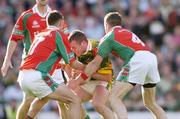 26 September 2004; Dara O Cinneide, Kerry, in action against Pat Kelly, 7, and Gary Ruane, Mayo. Bank of Ireland All-Ireland Senior Football Championship Final, Kerry v Mayo, Croke Park, Dublin. Picture credit; Ray McManus / SPORTSFILE *** Local Caption *** Any photograph taken by SPORTSFILE during, or in connection with, the 2004 Bank of Ireland All-Ireland Senior Football Final which displays GAA logos or contains an image or part of an image of any GAA intellectual property, or, which contains images of a GAA player/players in their playing uniforms, may only be used for editorial and non-advertising purposes.  Use of photographs for advertising, as posters or for purchase separately is strictly prohibited unless prior written approval has been obtained from the Gaelic Athletic Association.