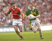 26 September 2004; Colm Cooper, Kerry, in action against Dermot Geraghty, Mayo. Bank of Ireland All-Ireland Senior Football Championship Final, Kerry v Mayo, Croke Park, Dublin. Picture credit; Damien Eagers / SPORTSFILE *** Local Caption *** Any photograph taken by SPORTSFILE during, or in connection with, the 2004 Bank of Ireland All-Ireland Senior Football Final which displays GAA logos or contains an image or part of an image of any GAA intellectual property, or, which contains images of a GAA player/players in their playing uniforms, may only be used for editorial and non-advertising purposes.  Use of photographs for advertising, as posters or for purchase separately is strictly prohibited unless prior written approval has been obtained from the Gaelic Athletic Association.