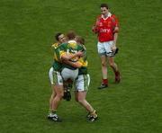 26 September 2004; Kerry team-mates Ronan O'Connor, left, Colm Cooper, centre, and Mike Frank Russell, right, celebrate victory as Mayo's Peadar Gardiner looks on. Bank of Ireland All-Ireland Senior Football Championship Final, Kerry v Mayo, Croke Park, Dublin. Picture credit; Pat Murphy / SPORTSFILE *** Local Caption *** Any photograph taken by SPORTSFILE during, or in connection with, the 2004 Bank of Ireland All-Ireland Senior Football Final which displays GAA logos or contains an image or part of an image of any GAA intellectual property, or, which contains images of a GAA player/players in their playing uniforms, may only be used for editorial and non-advertising purposes.  Use of photographs for advertising, as posters or for purchase separately is strictly prohibited unless prior written approval has been obtained from the Gaelic Athletic Association.