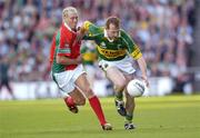 26 September 2004; Liam Hassett, Kerry, in action against Kieran McDonald, Mayo. Bank of Ireland All-Ireland Senior Football Championship Final, Kerry v Mayo, Croke Park, Dublin. Picture credit; Damien Eagers / SPORTSFILE *** Local Caption *** Any photograph taken by SPORTSFILE during, or in connection with, the 2004 Bank of Ireland All-Ireland Senior Football Final which displays GAA logos or contains an image or part of an image of any GAA intellectual property, or, which contains images of a GAA player/players in their playing uniforms, may only be used for editorial and non-advertising purposes.  Use of photographs for advertising, as posters or for purchase separately is strictly prohibited unless prior written approval has been obtained from the Gaelic Athletic Association.