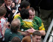 26 September 2004; Kerry's Seamus Moynihan is congratuled by team-mate Paul Galvin, left, after victory over Mayo. Bank of Ireland All-Ireland Senior Football Championship Final, Kerry v Mayo, Croke Park, Dublin. Picture credit; Pat Murphy / SPORTSFILE *** Local Caption *** Any photograph taken by SPORTSFILE during, or in connection with, the 2004 Bank of Ireland All-Ireland Senior Football Final which displays GAA logos or contains an image or part of an image of any GAA intellectual property, or, which contains images of a GAA player/players in their playing uniforms, may only be used for editorial and non-advertising purposes.  Use of photographs for advertising, as posters or for purchase separately is strictly prohibited unless prior written approval has been obtained from the Gaelic Athletic Association.