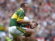 26 September 2004; John Crowley, Kerry, in action against Dermot Geraghty, Mayo. Bank of Ireland All-Ireland Senior Football Championship Final, Kerry v Mayo, Croke Park, Dublin. Picture credit; Brian Lawless / SPORTSFILE *** Local Caption *** Any photograph taken by SPORTSFILE during, or in connection with, the 2004 Bank of Ireland All-Ireland Senior Football Final which displays GAA logos or contains an image or part of an image of any GAA intellectual property, or, which contains images of a GAA player/players in their playing uniforms, may only be used for editorial and non-advertising purposes.  Use of photographs for advertising, as posters or for purchase separately is strictly prohibited unless prior written approval has been obtained from the Gaelic Athletic Association.
