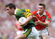 26 September 2004; Declan O'Sullivan, Kerry, in action against Dermot Geraghty, Mayo. Bank of Ireland All-Ireland Senior Football Championship Final, Kerry v Mayo, Croke Park, Dublin. Picture credit; Brian Lawless / SPORTSFILE *** Local Caption *** Any photograph taken by SPORTSFILE during, or in connection with, the 2004 Bank of Ireland All-Ireland Senior Football Final which displays GAA logos or contains an image or part of an image of any GAA intellectual property, or, which contains images of a GAA player/players in their playing uniforms, may only be used for editorial and non-advertising purposes.  Use of photographs for advertising, as posters or for purchase separately is strictly prohibited unless prior written approval has been obtained from the Gaelic Athletic Association.