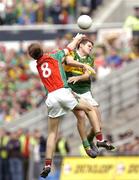 26 September 2004; Eoin Brosnan, Kerry, in action against Ronan McGarrity, Mayo. Bank of Ireland All-Ireland Senior Football Championship Final, Kerry v Mayo, Croke Park, Dublin. Picture credit; Brendan Moran / SPORTSFILE *** Local Caption *** Any photograph taken by SPORTSFILE during, or in connection with, the 2004 Bank of Ireland All-Ireland Senior Football Final which displays GAA logos or contains an image or part of an image of any GAA intellectual property, or, which contains images of a GAA player/players in their playing uniforms, may only be used for editorial and non-advertising purposes.  Use of photographs for advertising, as posters or for purchase separately is strictly prohibited unless prior written approval has been obtained from the Gaelic Athletic Association.