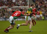 26 September 2004; Seamus Moynihan, Kerry, in action against Peadar Gardnier, Mayo. Bank of Ireland All-Ireland Senior Football Championship Final, Kerry v Mayo, Croke Park, Dublin. Picture credit; Ray McManus / SPORTSFILE *** Local Caption *** Any photograph taken by SPORTSFILE during, or in connection with, the 2004 Bank of Ireland All-Ireland Senior Football Final which displays GAA logos or contains an image or part of an image of any GAA intellectual property, or, which contains images of a GAA player/players in their playing uniforms, may only be used for editorial and non-advertising purposes.  Use of photographs for advertising, as posters or for purchase separately is strictly prohibited unless prior written approval has been obtained from the Gaelic Athletic Association.