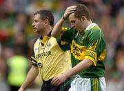 26 September 2004; Luke Quinn, Kerry, with team manager Sean Geaney after the game. All-Ireland Minor Football Championship Final, Kerry v Tyrone, Croke Park, Dublin. Picture credit; Ray McManus / SPORTSFILE *** Local Caption *** Any photograph taken by SPORTSFILE during, or in connection with, the 2004 All-Ireland Minor Football Final which displays GAA logos or contains an image or part of an image of any GAA intellectual property, or, which contains images of a GAA player/players in their playing uniforms, may only be used for editorial and non-advertising purposes.  Use of photographs for advertising, as posters or for purchase separately is strictly prohibited unless prior written approval has been obtained from the Gaelic Athletic Association.