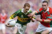 26 September 2004; Colm Cooper, Kerry, in action against Pat Kelly, Mayo. Bank of Ireland All-Ireland Senior Football Championship Final, Kerry v Mayo, Croke Park, Dublin. Picture credit; Brendan Moran / SPORTSFILE *** Local Caption *** Any photograph taken by SPORTSFILE during, or in connection with, the 2004 Bank of Ireland All-Ireland Senior Football Final which displays GAA logos or contains an image or part of an image of any GAA intellectual property, or, which contains images of a GAA player/players in their playing uniforms, may only be used for editorial and non-advertising purposes.  Use of photographs for advertising, as posters or for purchase separately is strictly prohibited unless prior written approval has been obtained from the Gaelic Athletic Association.
