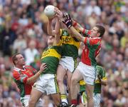 26 September 2004; Seamus Moynihan supported by team-mate Eoin Brosnan, left, Kerry, in action against Mayo's David Brady, left, and Paddy Navin. Bank of Ireland All-Ireland Senior Football Championship Final, Kerry v Mayo, Croke Park, Dublin. Picture credit; Brian Lawless / SPORTSFILE *** Local Caption *** Any photograph taken by SPORTSFILE during, or in connection with, the 2004 Bank of Ireland All-Ireland Senior Football Final which displays GAA logos or contains an image or part of an image of any GAA intellectual property, or, which contains images of a GAA player/players in their playing uniforms, may only be used for editorial and non-advertising purposes.  Use of photographs for advertising, as posters or for purchase separately is strictly prohibited unless prior written approval has been obtained from the Gaelic Athletic Association.