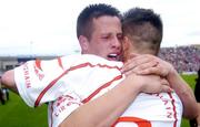 26 September 2004; Tyrone's Shane O'Hagan, left, celebrates with team-mate Niall Kerr after victory over Kerry. All-Ireland Minor Football Championship Final, Kerry v Tyrone, Croke Park, Dublin. Picture credit; Brian Lawless / SPORTSFILE *** Local Caption *** Any photograph taken by SPORTSFILE during, or in connection with, the 2004 All-Ireland Minor Football Final which displays GAA logos or contains an image or part of an image of any GAA intellectual property, or, which contains images of a GAA player/players in their playing uniforms, may only be used for editorial and non-advertising purposes.  Use of photographs for advertising, as posters or for purchase separately is strictly prohibited unless prior written approval has been obtained from the Gaelic Athletic Association.