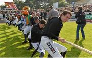 14 October 2013; Jockeys, led by captain Paddy Mullins, compete in a tug-of-war match at the Limerick Charity Race Day for the jockeys emergency fund. Limerick Racecourse, Greenmount Park, Co. Limerick. Picture credit: Diarmuid Greene / SPORTSFILE