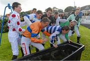14 October 2013; Jockey Johnny Murtagh is dunked into a water trough by fellow jockeys after winning the Betfair Cash Out Flat & National Hunt Champion Jockeys Handicap on Goal at the Limerick Charity Race Day for the jockeys emergency fund. Limerick Racecourse, Greenmount Park, Co. Limerick. Picture credit: Diarmuid Greene / SPORTSFILE