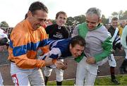 14 October 2013; Jockey Johnny Murtagh is carried towards a water trough by fellow jockeys, Davy Russell, left, Tony McCoy, centre, and Ruby Walsh, right, after winning the Betfair Cash Out Flat & National Hunt Champion Jockeys Handicap on Goal at the Limerick Charity Race Day for the jockeys emergency fund. Limerick Racecourse, Greenmount Park, Co. Limerick. Picture credit: Diarmuid Greene / SPORTSFILE