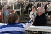 14 October 2013; Jockey Johnny Murtagh offers his hand and an apology to 2-year-old Aaron Palmer, from Liscarroll, Co. Cork, accompanied by Ted Walsh, after he threw a bucket of water towards spectators following his win in the Betfair Cash Out Flat & National Hunt Champion Jockeys Handicap on Goal at the Limerick Charity Race Day for the jockeys emergency fund. Limerick Racecourse, Greenmount Park, Co. Limerick. Picture credit: Diarmuid Greene / SPORTSFILE