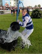 14 October 2013; Jockey Johnny Murtagh throws a bucket of water towards spectators following his win in the Betfair Cash Out Flat & National Hunt Champion Jockeys Handicap on Goal at the Limerick Charity Race Day for the jockeys emergency fund. Limerick Racecourse, Greenmount Park, Co. Limerick. Picture credit: Diarmuid Greene / SPORTSFILE