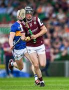 21 June 2025; Kevin Cooney of Galway races clear of Bryan O'Mara of Tipperary during the GAA Hurling All-Ireland Senior Championship quarter-final match between Galway and Tipperary at TUS Gaelic Grounds in Limerick. Photo by Ray McManus/Sportsfile
