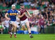 21 June 2025; Kevin Cooney of Galway races clear of Bryan O'Mara of Tipperary during the GAA Hurling All-Ireland Senior Championship quarter-final match between Galway and Tipperary at TUS Gaelic Grounds in Limerick. Photo by Ray McManus/Sportsfile