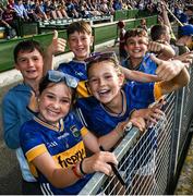 21 June 2025; Young Tipperary supporters celebrate near the end of the GAA Hurling All-Ireland Senior Championship quarter-final match between Galway and Tipperary at TUS Gaelic Grounds in Limerick. Photo by Ray McManus/Sportsfile