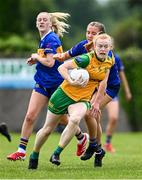 21 June 2025; Evelyn McGinley of Donegal in action against Nora Martin of Tipperary during the TG4 All-Ireland Ladies Football Senior Championship Group 1 match between Tipperary and Donegal at Canon Hayes Park in Bansha, Tipperary. Photo by Seb Daly/Sportsfile