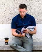 22 June 2025; GAA+ analyst Marc Ó Sé inspects the match programme before the GAA Football All-Ireland Senior Championship preliminary quarter-final match between Down and Galway at Páirc Esler in Newry, Down. Photo by Ben McShane/Sportsfile