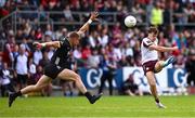 22 June 2025; Robert Finnerty of Galway kicks a point despite the attention of Pat Havern of Down during the GAA Football All-Ireland Senior Championship preliminary quarter-final match between Down and Galway at Páirc Esler in Newry, Down. Photo by Ben McShane/Sportsfile