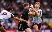 22 June 2025; Ryan Magill of Down is tackled by John Maher, left, and Cian Hernon of Galway during the GAA Football All-Ireland Senior Championship preliminary quarter-final match between Down and Galway at Páirc Esler in Newry, Down. Photo by Ben McShane/Sportsfile