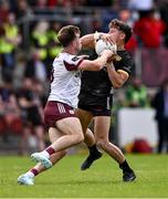22 June 2025; Pierce Laverty of Down is tackled by Paul Conroy of Galway during the GAA Football All-Ireland Senior Championship preliminary quarter-final match between Down and Galway at Páirc Esler in Newry, Down. Photo by Ben McShane/Sportsfile