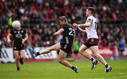 22 June 2025; Caolan Mooney of Down kicks a point despite the attention of Cein Darcy of Galway during the GAA Football All-Ireland Senior Championship preliminary quarter-final match between Down and Galway at Páirc Esler in Newry, Down. Photo by Ben McShane/Sportsfile