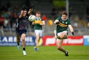 22 June 2025; Ben Kelleher of Kerry kicks a point despite the efforts of Cahair Tighe of Mayo during the Electric Ireland GAA Football All-Ireland Minor Championship semi-final match between Kerry and Mayo at Zimmer Biomet Páirc Chíosóg in Ennis, Clare. Photo by Brendan Moran/Sportsfile