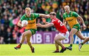 22 June 2025; Oisin Gallen of Donegal in action against Dan Corcoran of Louth during the GAA Football All-Ireland Senior Championship preliminary quarter-final match between Donegal and Louth at MacCumhaill Park in Ballybofey, Donegal. Photo by Ramsey Cardy/Sportsfile