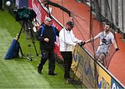 22 June 2025; Kevin Flynn of Kildare awaits help from TV camera operator Joe O'Byrne and umpire Fergal McCrory to get free from the ball-stopper net behind the goals after chasing a loose ball during the Tailteann Cup semi-final match between Kildare and Fermanagh at Croke Park in Dublin. Photo by Piaras Ó Mídheach/Sportsfile