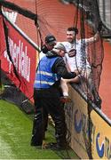 22 June 2025; Kevin Flynn of Kildare gets help from TV camera operator Joe O'Byrne and umpire Fergal McCrory to get free from the ball-stopper net behind the goals after chasing a loose ball during the Tailteann Cup semi-final match between Kildare and Fermanagh at Croke Park in Dublin. Photo by Piaras Ó Mídheach/Sportsfile