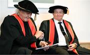 23 June 2025; Ssinger Johnny Logan, formally known as Sean Patrick Sherrard, left, shakes hands with Irish sports broadcaster Marty Morrissey as they receive their honorary doctorial awards at the Longford International College Graduation Ceremony 2025 at the Radisson Blu Dublin Airport Hotel in Dublin. Photo by Shauna Clinton/Sportsfile