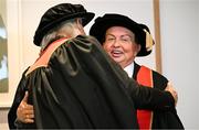 23 June 2025; Irish sports broadcaster Marty Morrissey, right, and singer Johnny Logan, formally known as Sean Patrick Sherrard, hug as they receive their honorary doctorial awards at the Longford International College Graduation Ceremony 2025 at the Radisson Blu Dublin Airport Hotel in Dublin. Photo by Shauna Clinton/Sportsfile