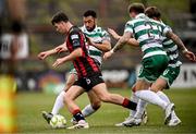 23 June 2025; James Clarke of Bohemians is tackled by Shamrock Rovers players, from left, Roberto Lopes, Danny Grant and Daniel Cleary during the SSE Airtricity Men's Premier Division match between Bohemians and Shamrock Rovers at Dalymount Park in Dublin. Photo by Ramsey Cardy/Sportsfile