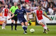 23 June 2025; Gavin Whyte of Derry City in action against Jamie Lennon of St Patrick's Athletic during the SSE Airtricity Men's Premier Division match between St Patrick's Athletic and Derry City at Richmond Park in Dublin. Photo by Ben McShane/Sportsfile