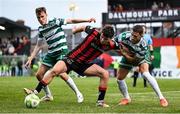 23 June 2025; James Clarke of Bohemians in action against Shamrock Rovers players Matt Healy, left, and Lee Grace during the SSE Airtricity Men's Premier Division match between Bohemians and Shamrock Rovers at Dalymount Park in Dublin. Photo by Shauna Clinton/Sportsfile
